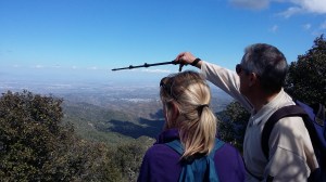 Walk leader identifying a location at a viewpoint